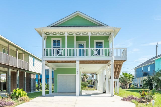 coastal inspired home with covered porch, a garage, and a carport