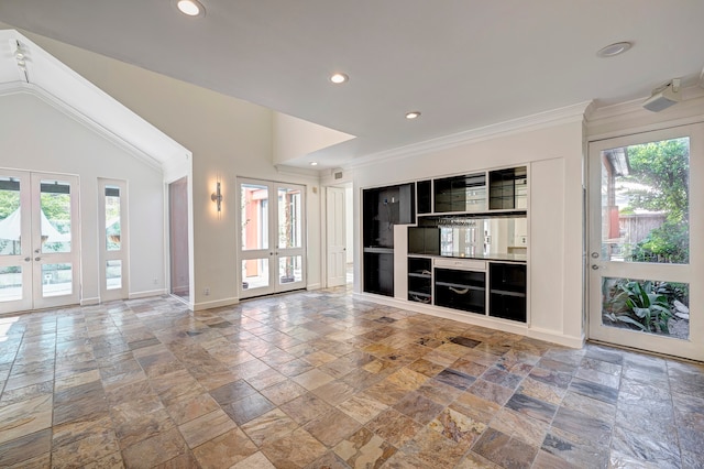 unfurnished living room featuring french doors, ornamental molding, and a wealth of natural light