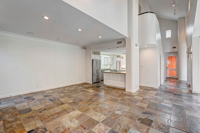 unfurnished living room with crown molding