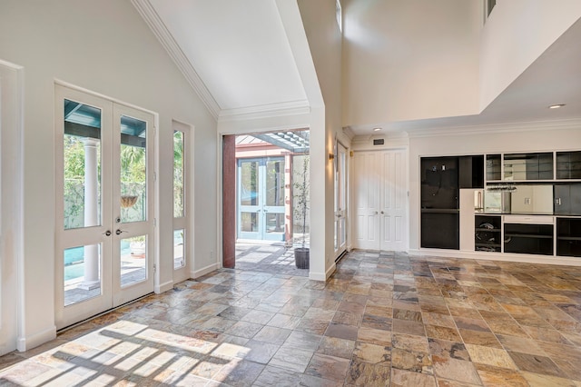 entrance foyer with a healthy amount of sunlight, french doors, and high vaulted ceiling