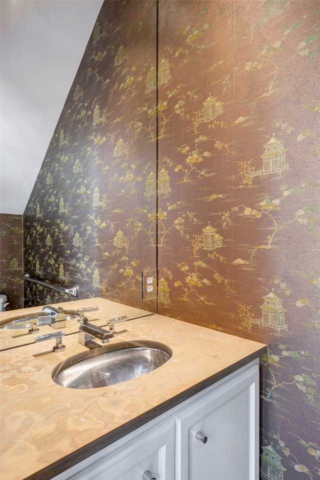 bathroom featuring vanity and vaulted ceiling