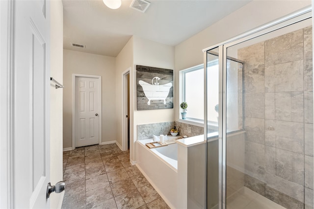 full bath with visible vents, a stall shower, baseboards, and a garden tub