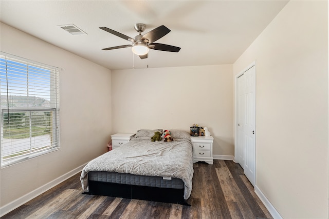 bedroom with a ceiling fan, dark wood-type flooring, baseboards, and visible vents