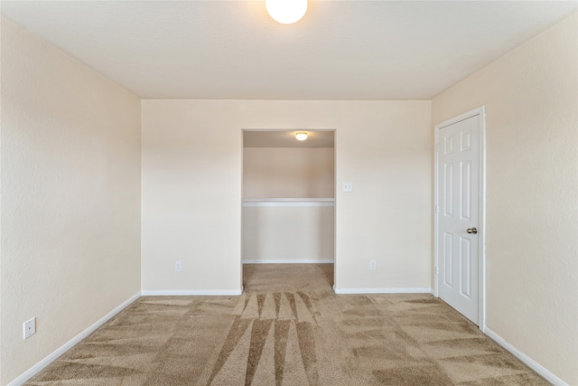 unfurnished room featuring baseboards and carpet flooring