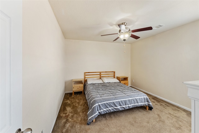 bedroom with visible vents, carpet floors, baseboards, and ceiling fan