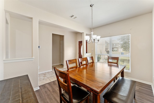 dining space featuring a chandelier and wood-type flooring