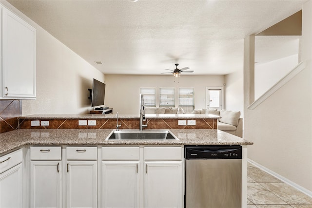 kitchen with sink, a textured ceiling, ceiling fan, stainless steel dishwasher, and white cabinets