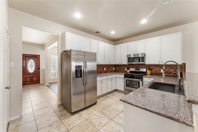 kitchen featuring a sink, stainless steel appliances, visible vents, and white cabinetry