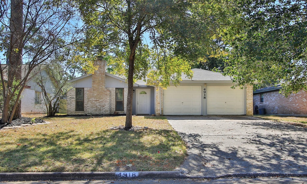 ranch-style home with a front yard and a garage