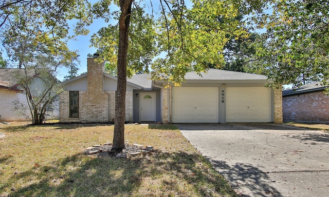 ranch-style home featuring a front lawn and a garage