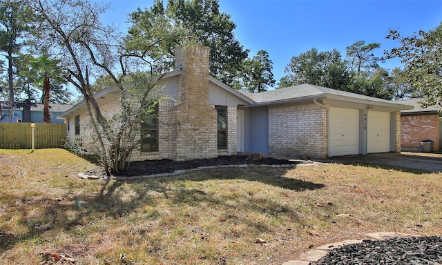 view of side of property with a lawn and a garage