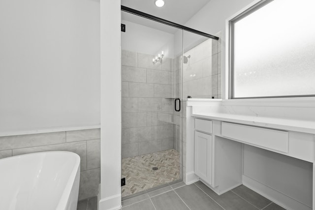 bathroom featuring tile patterned floors and shower with separate bathtub