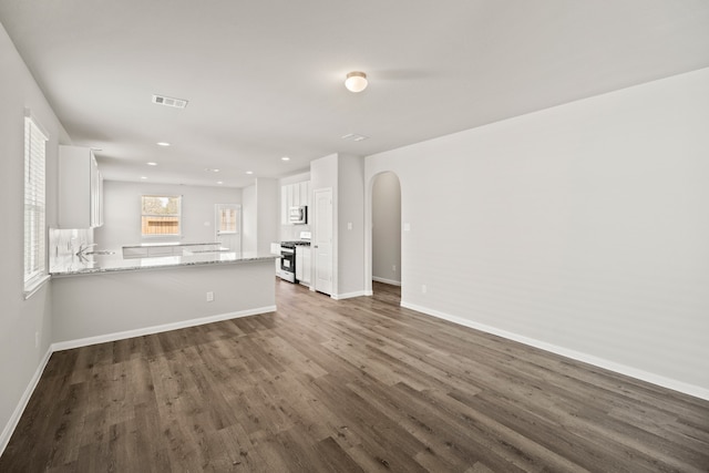 unfurnished living room featuring dark wood-type flooring