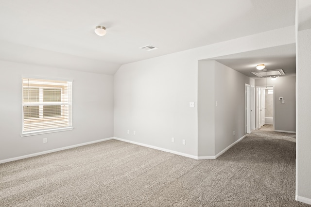 unfurnished room featuring carpet flooring and vaulted ceiling