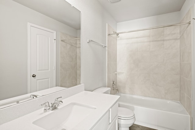 full bathroom featuring toilet, tiled shower / bath, and vanity