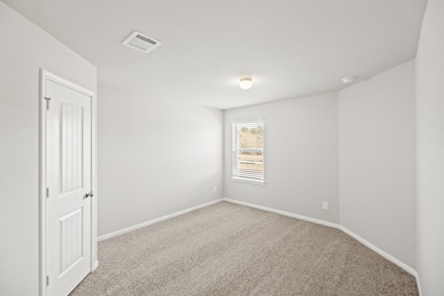 spare room with light colored carpet