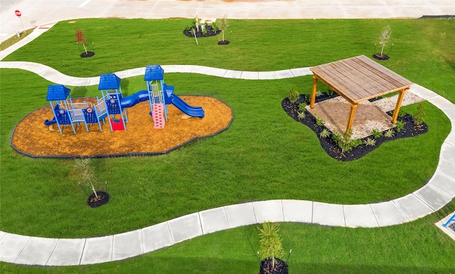 view of property's community with a lawn and a playground