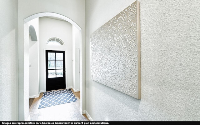 foyer entrance with baseboards and wood finished floors