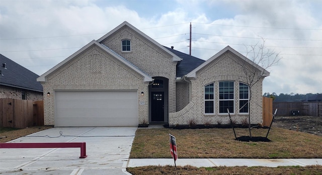 view of front of house with a garage, brick siding, fence, a front lawn, and concrete driveway