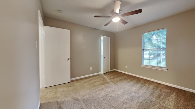 empty room with ceiling fan and carpet floors