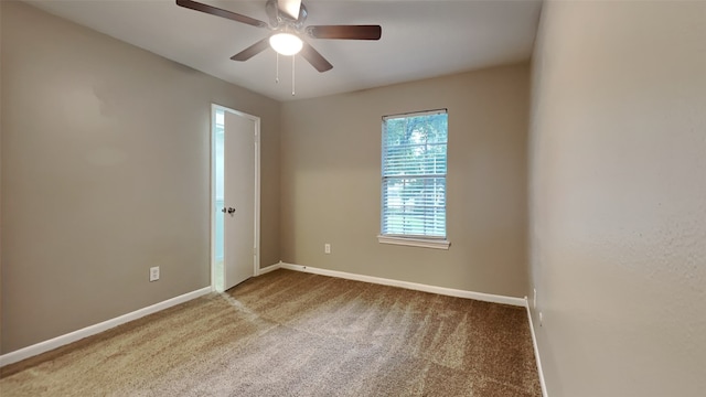 carpeted empty room featuring ceiling fan