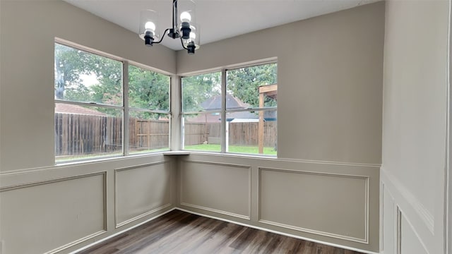 unfurnished sunroom with a notable chandelier