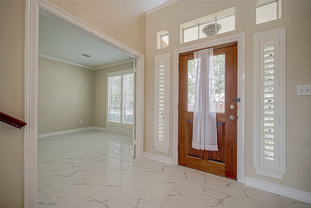 entrance foyer featuring a wealth of natural light and crown molding