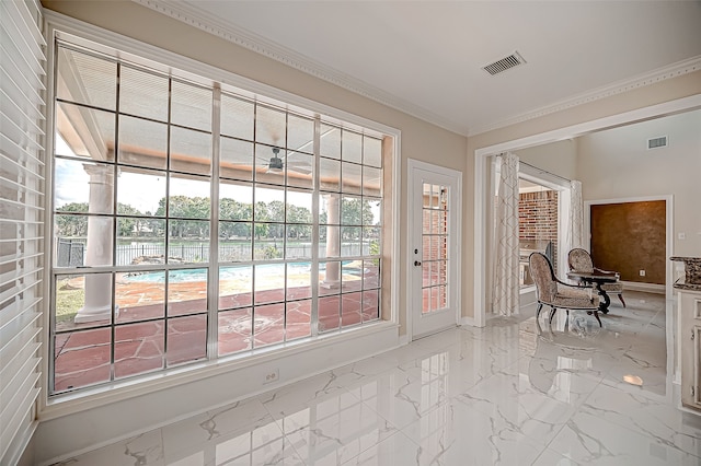 doorway to outside with ceiling fan and crown molding