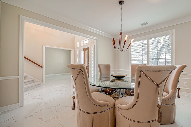 dining space with crown molding and a notable chandelier