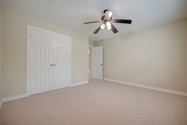 unfurnished bedroom featuring ceiling fan, carpet floors, and a closet