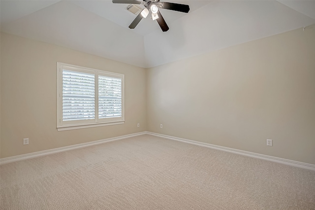 carpeted empty room with a raised ceiling and ceiling fan