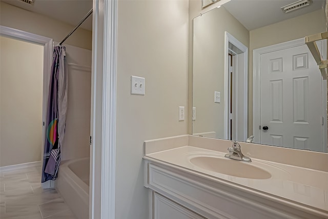 bathroom with shower / tub combo with curtain, vanity, and tile patterned flooring