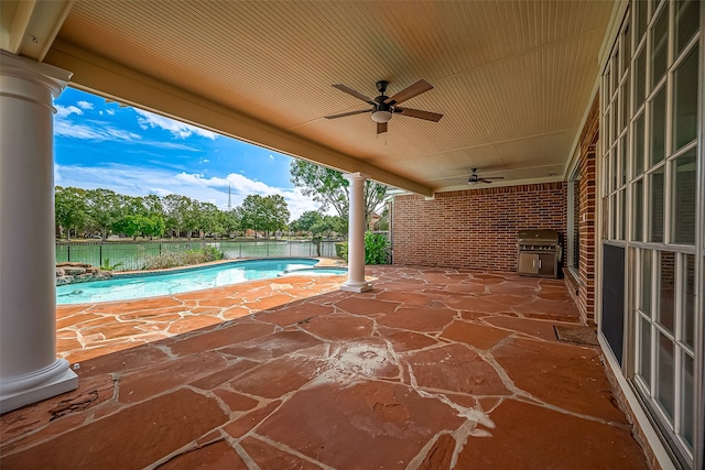 view of pool with ceiling fan, a patio area, and grilling area