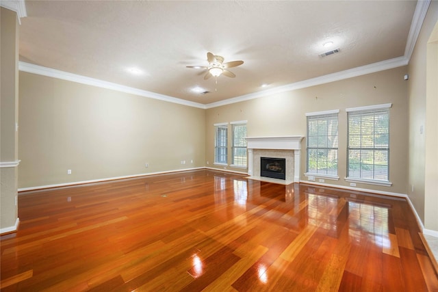 unfurnished living room with wood-type flooring, ornamental molding, and ceiling fan