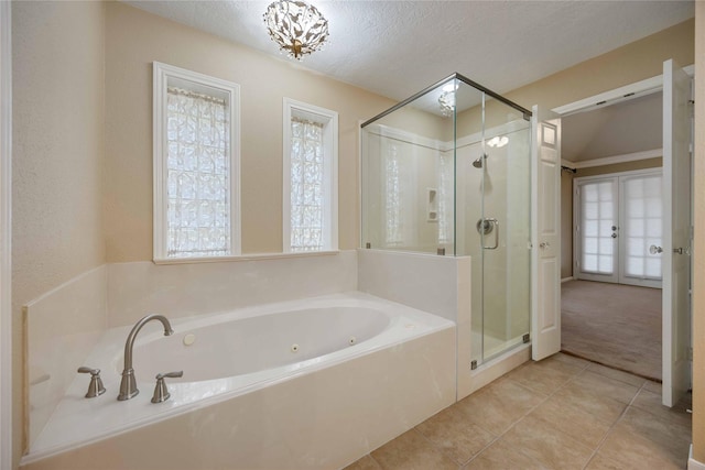 bathroom with french doors, tile patterned flooring, a textured ceiling, and independent shower and bath