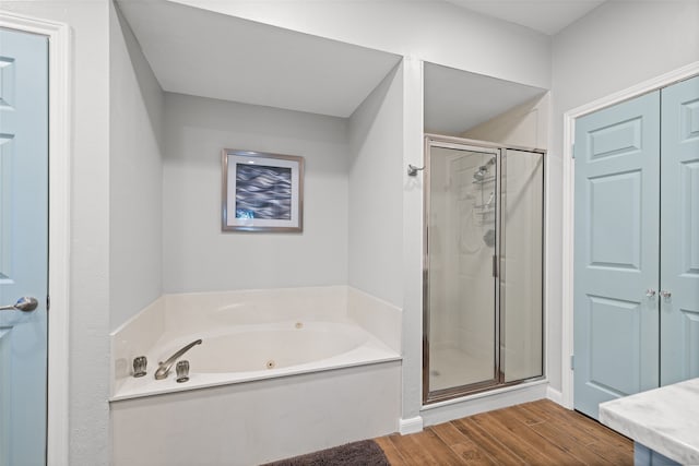 bathroom with hardwood / wood-style flooring and plus walk in shower