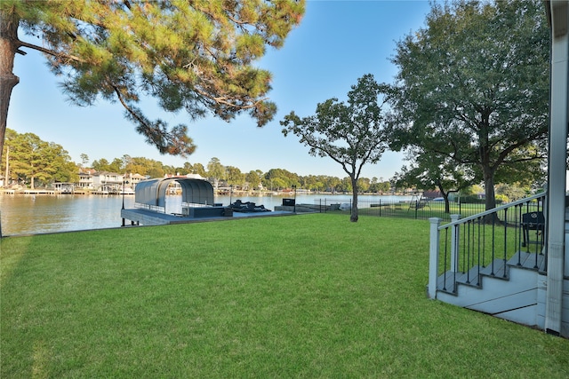 view of yard featuring a water view and a boat dock