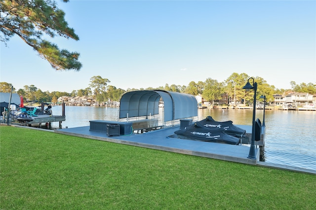 dock area with a water view and a lawn