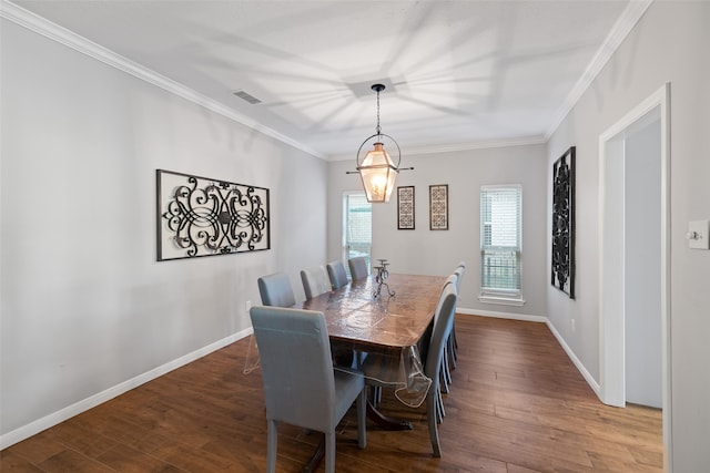 dining space featuring dark wood-type flooring and ornamental molding