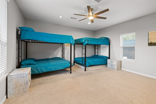 bedroom featuring light colored carpet and ceiling fan