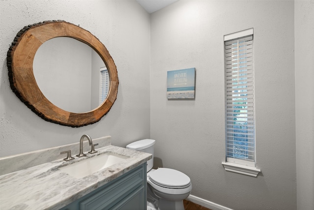 bathroom featuring toilet and vanity