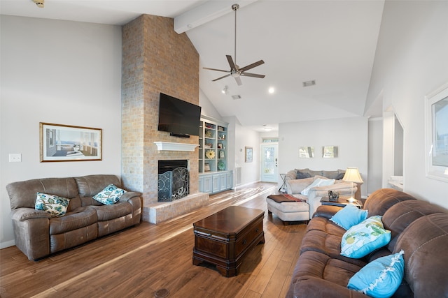 living room featuring a fireplace, hardwood / wood-style floors, ceiling fan, beam ceiling, and high vaulted ceiling