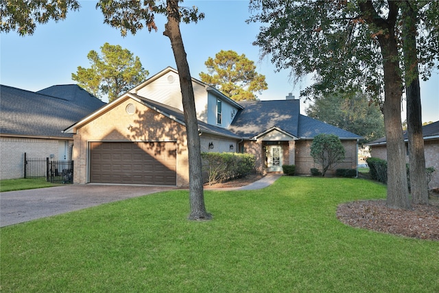 view of front of home with a front yard and a garage