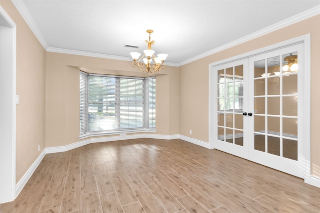 empty room with ornamental molding, french doors, a notable chandelier, and light wood-type flooring