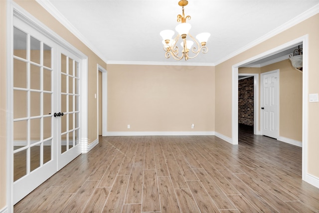 unfurnished room featuring a chandelier, crown molding, and light hardwood / wood-style floors