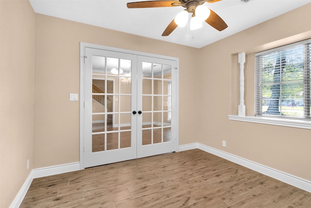 empty room featuring french doors, light wood-type flooring, and ceiling fan