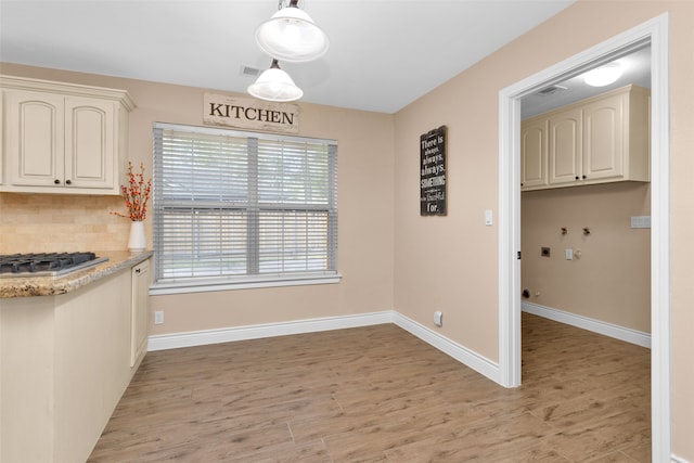 unfurnished dining area with light wood-type flooring