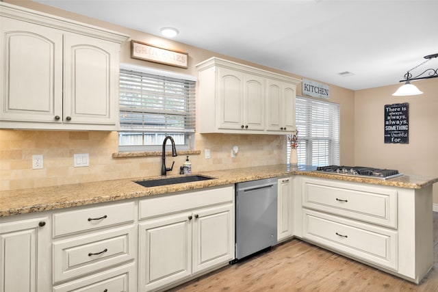 kitchen featuring sink, light hardwood / wood-style floors, stainless steel appliances, and a healthy amount of sunlight