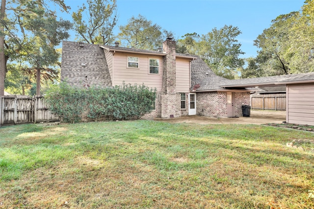 back of property featuring a patio area and a lawn