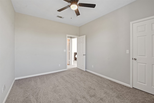 unfurnished room with ceiling fan and carpet